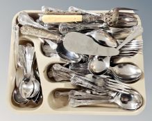 A plastic cutlery tray containing a set of stainless steel cutlery,