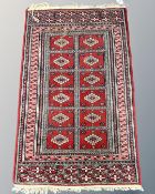 A Tekke design rug, 64cm by 103cm.