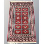 A Tekke design rug, 64cm by 103cm.