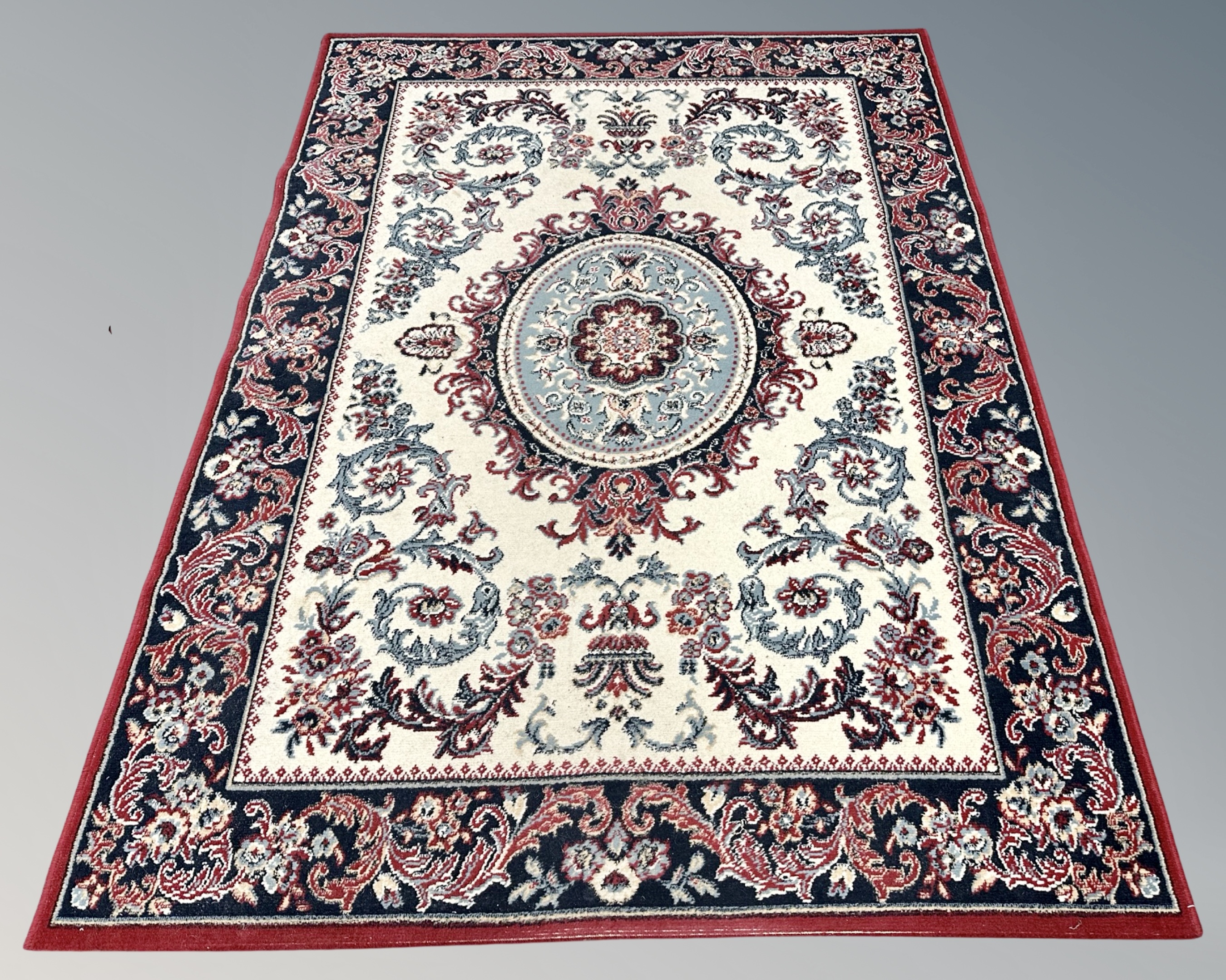 A machined Persian style rug, 164cm by 222cm.