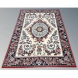 A machined Persian style rug, 164cm by 222cm.