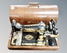 A vintage Singer hand sewing machine in case.