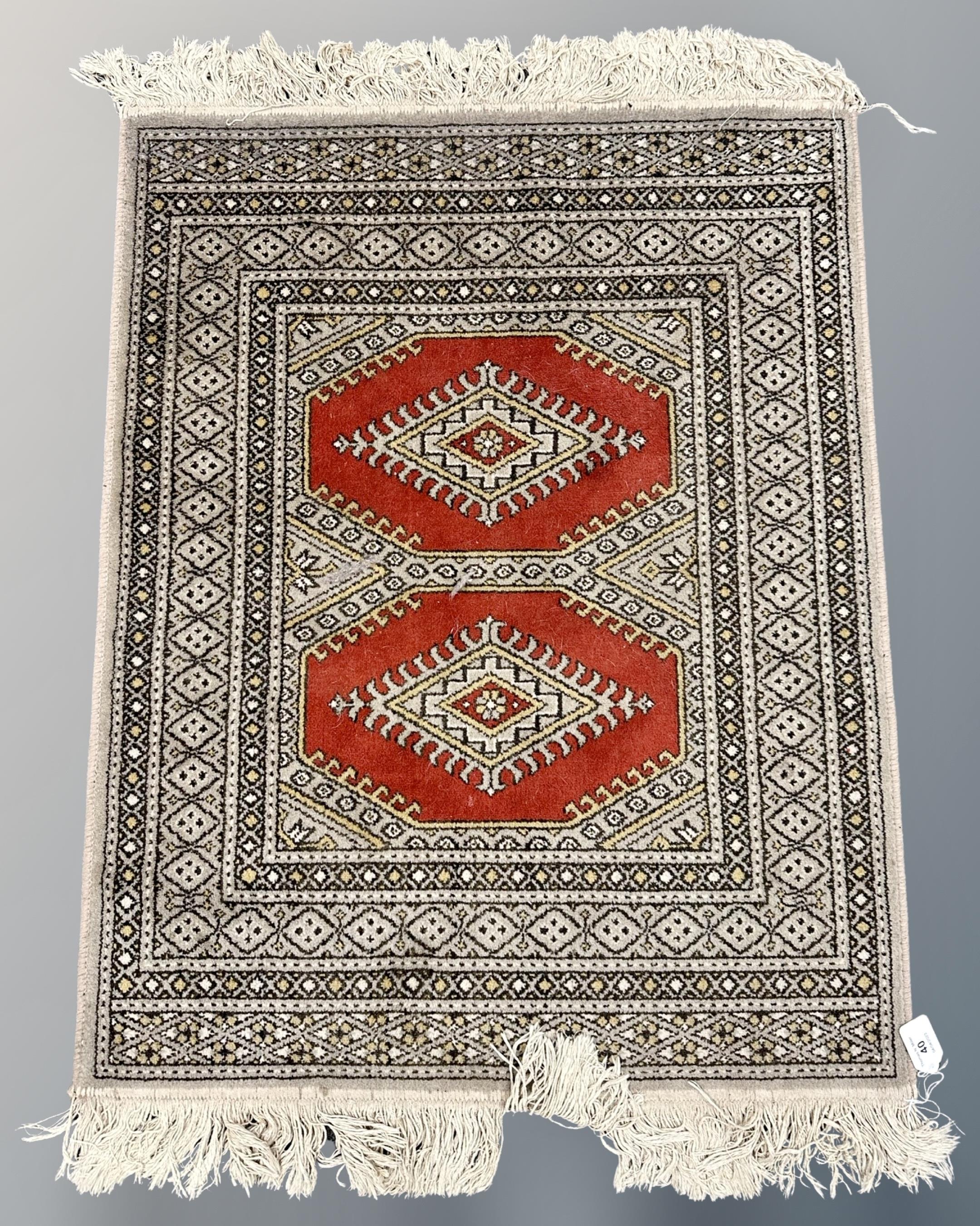 A Bokhara design rug, 72cm by 104cm.