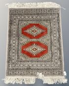 A Bokhara design rug, 72cm by 104cm.