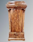 A 19th century continental flame mahogany bow front sentry door cabinet.