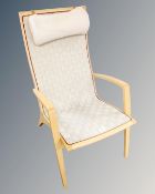 A Scandinavian beech framed armchair with canvas webbing seat.