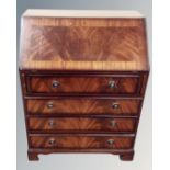 A mahogany fall front writing bureau fitted with four drawers.
