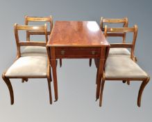 An inlaid yew wood drop leaf dining table and four chairs