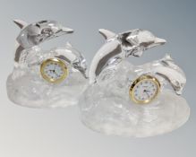 A pair of glass dolphin mantel clocks.