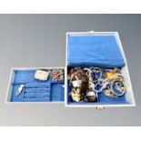 A blue box of costume jewellery, miniature purse, lady's watch,