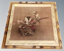 A Japanese style print depicting a basket of flowers in faux bamboo frame