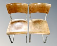 A pair of mid century tubular metal and plywood school chairs