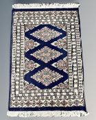 An Afghan/Caucasian rug 64 cm x 92 cm