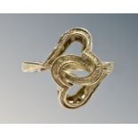 A 9ct yellow gold interlocking heart ring, 2.4g, size J/K.