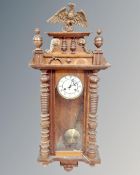 A 19th century continental eight day Vienna style wall clock with eagle pediment
