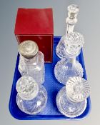 A tray of six cut glass and lead crystal decanters,