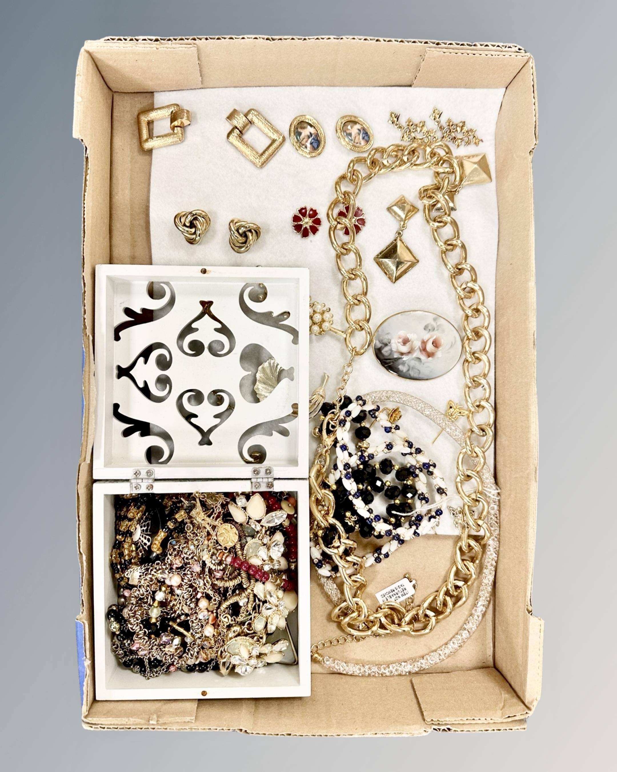 A box of costume jewellery, brooches and earrings,