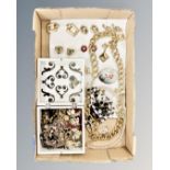 A box of costume jewellery, brooches and earrings,
