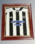 A framed Newcastle United Northern Rock football shirt with signatures, by repute Alan Shearer,
