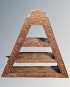 An antique carved oak wall shelf