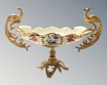 A decorative porcelain and gilt metal table centre piece with Bird of Paradise handles