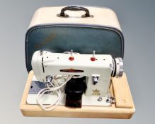 A vintage Dependable electric sewing machine in case