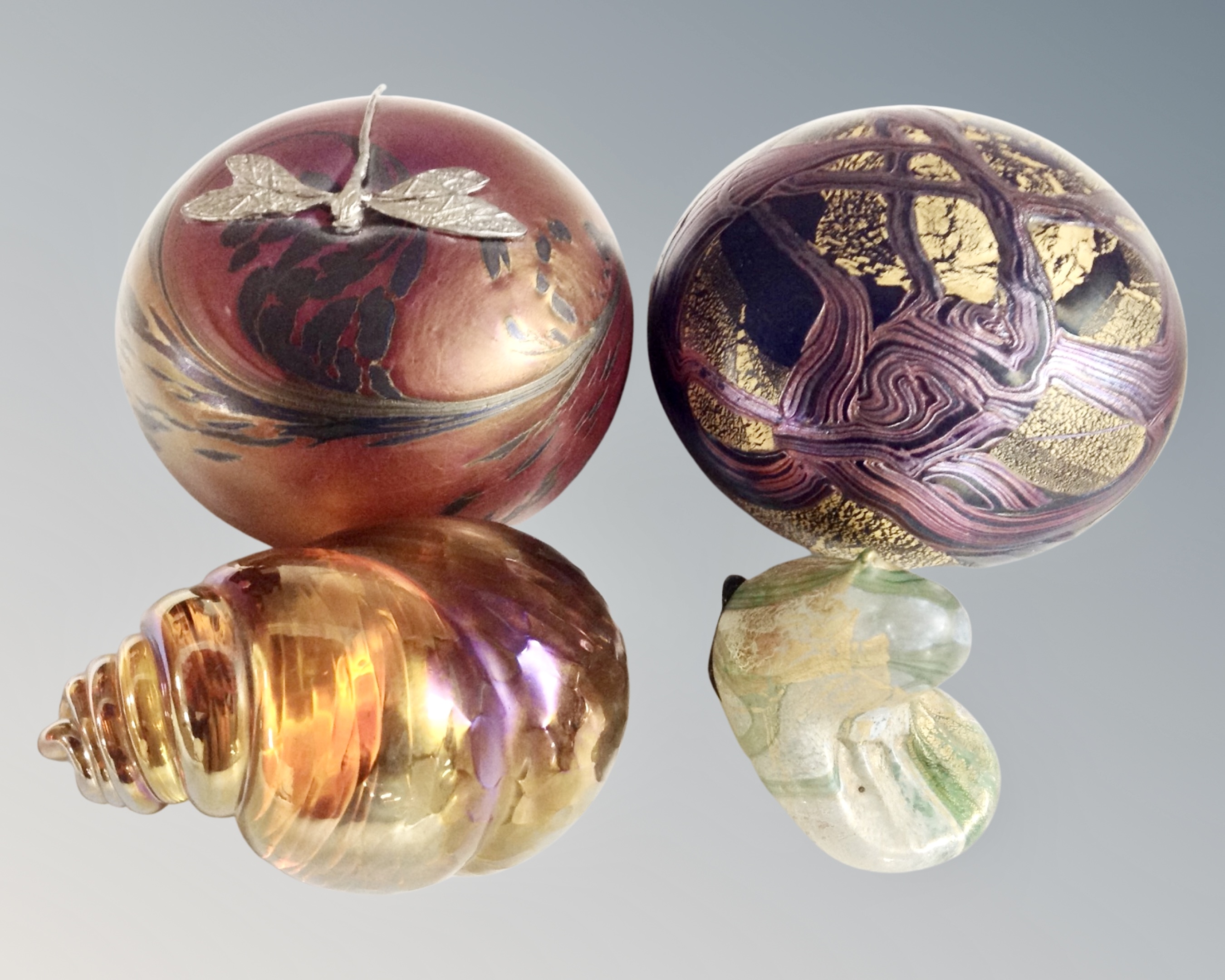 Four glass paperweights to include Cris Heaton irridescent dragon fly,
