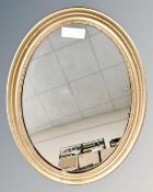 An antique oval gilt framed mirror