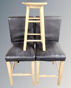 A pair of contemporary breakfast bar chairs and further bar stool