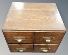 A 20th century oak desk top four drawer index chest