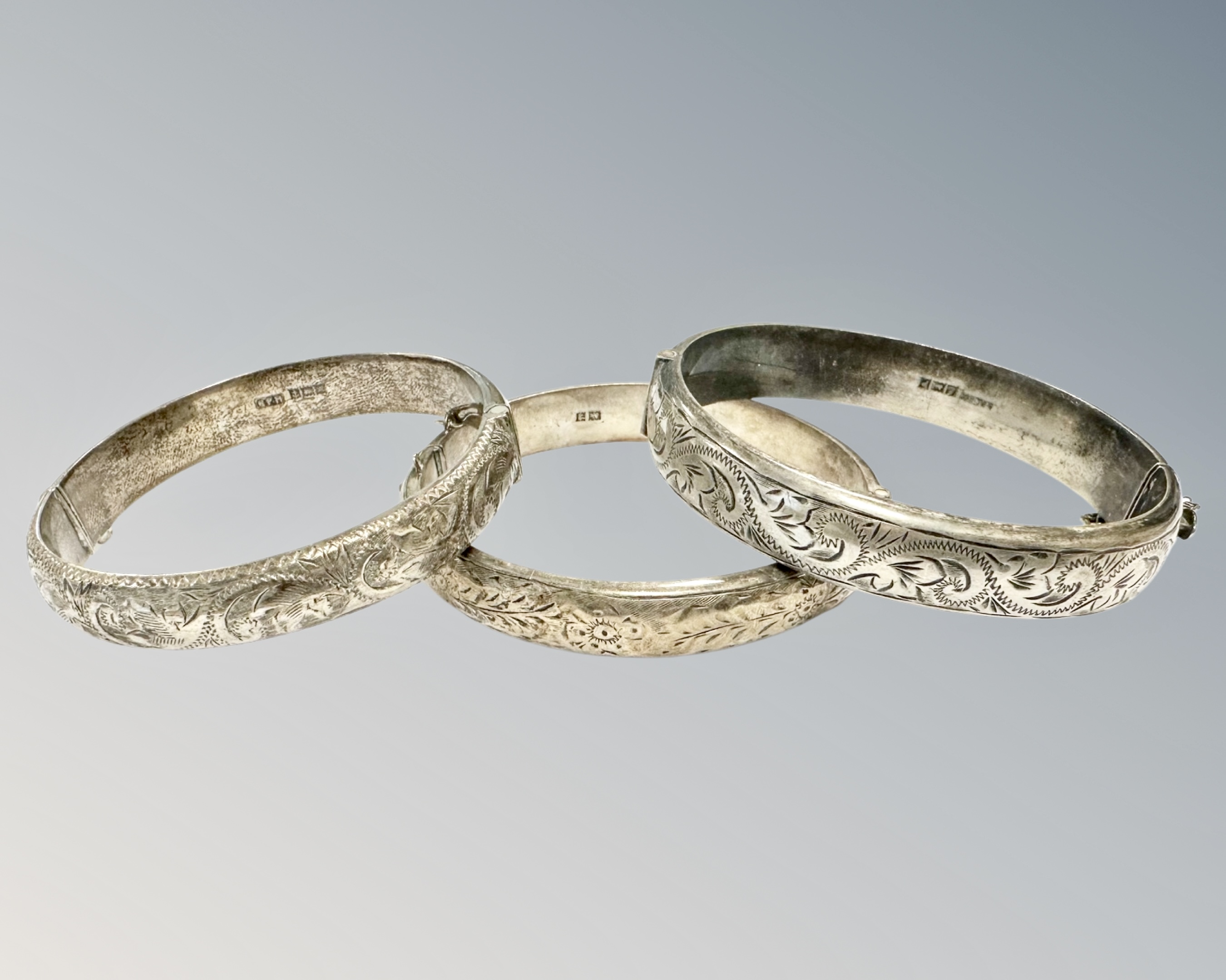 Three antique silver bangles, 51.7g.