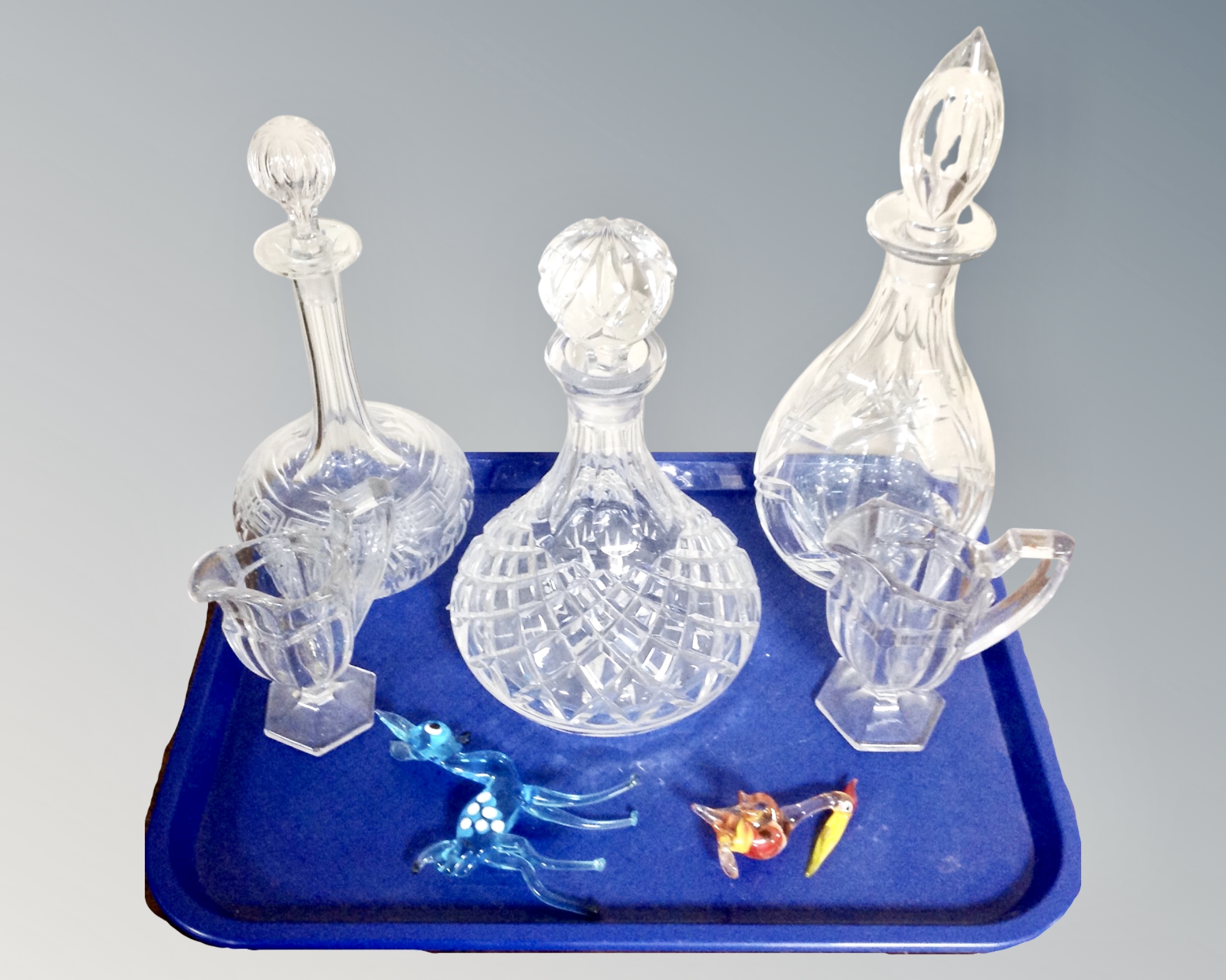 A tray of assorted glass ware, cut glass decanters, Venetian glass animal ornaments,