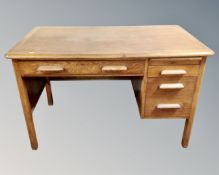 An Edwardian oak single pedestal desk fitted with four drawers