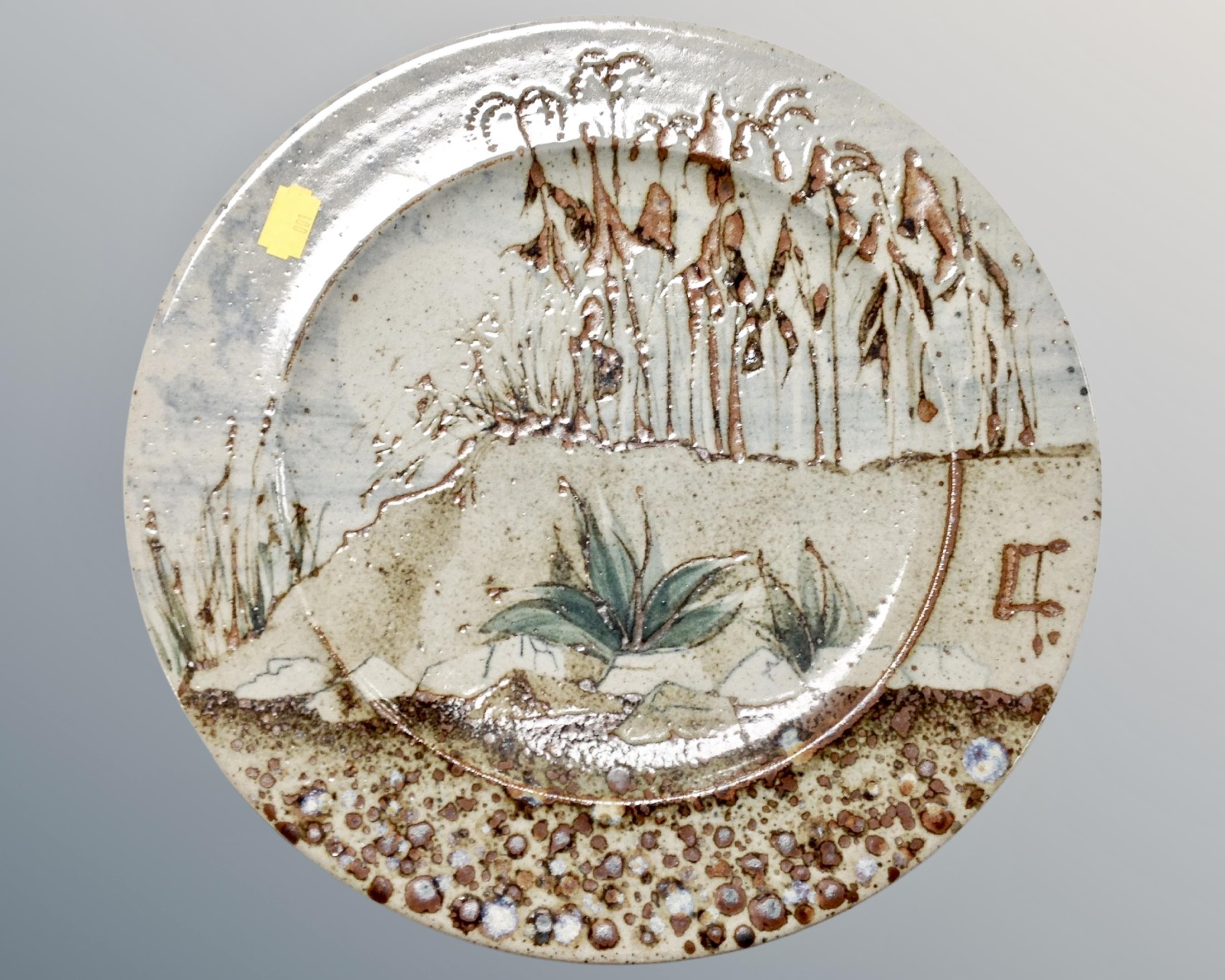 An Aurora project glazed pottery plate