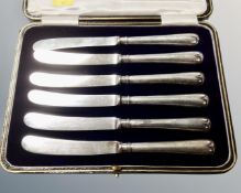 A set of six silver handled butter knives in case, Sheffield marks.
