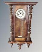 A Continental wall clock with brass and enamelled dial