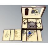 A Burgundy jewellery case containing costume jewellery, bangles etc.