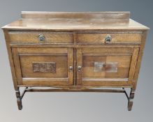 An Edwardian oak double door sideboard