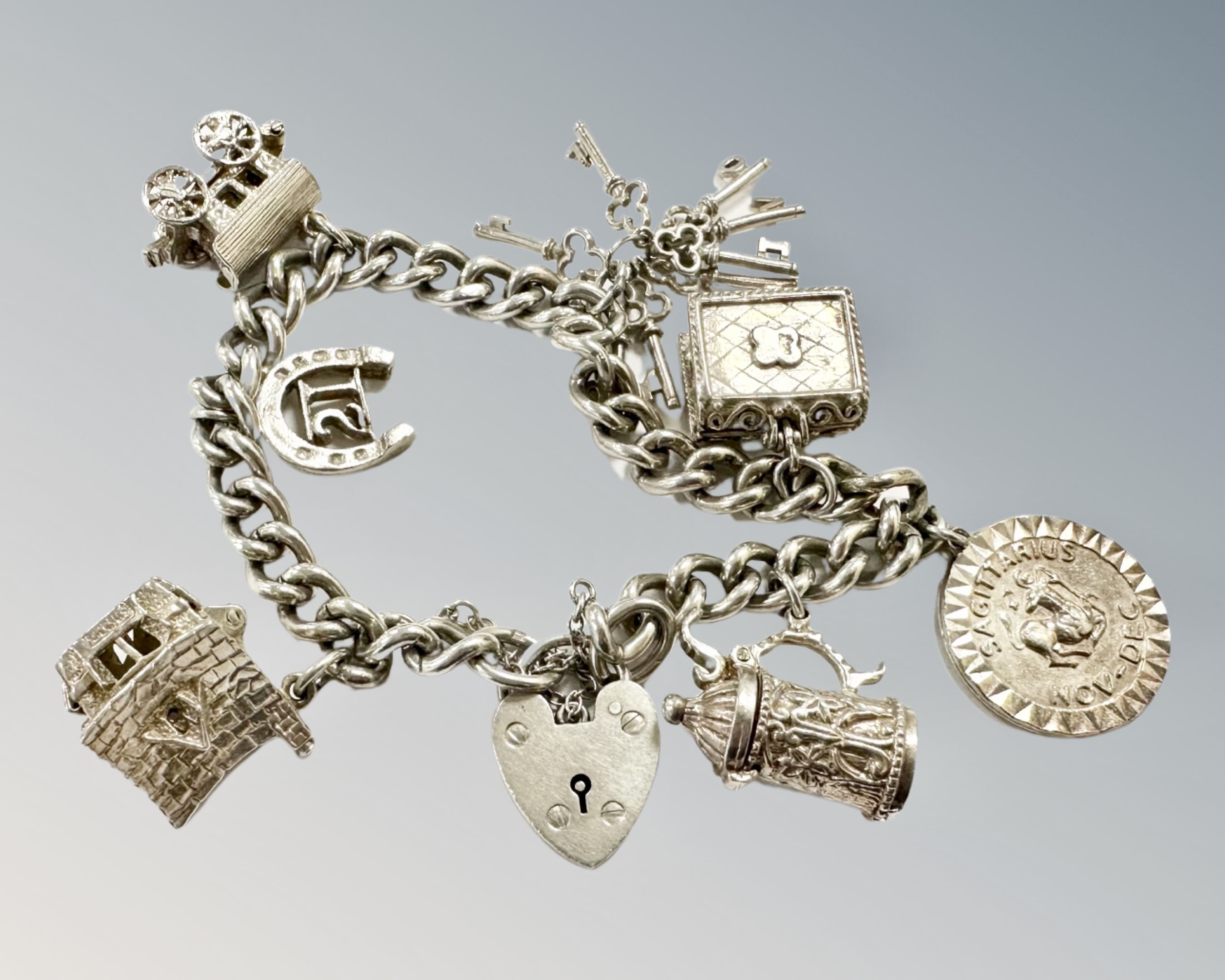 A silver charm bracelet, 55.