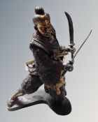 A patinated metal figure of a Samurai