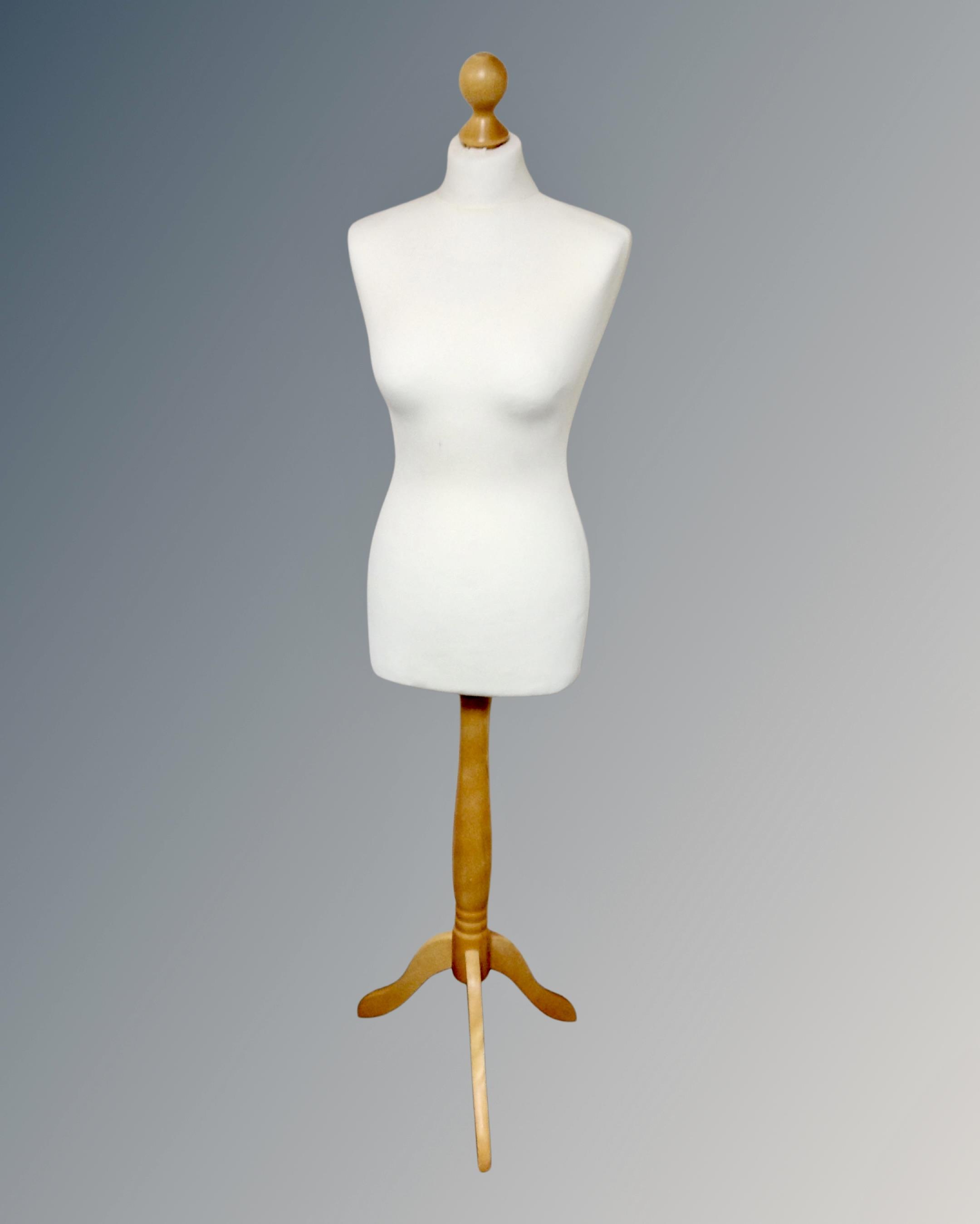 A dress maker's dummy on stand