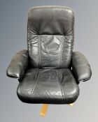 A Stouby black leather swivel armchair