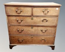 A Georgian oak five drawer chest on bracket feet