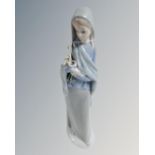 A Lladro china figure : Lady Holding Lillies, 23 cm.