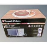 A Russell Hobbs compact microwave, boxed.