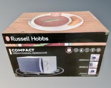 A Russell Hobbs compact microwave, boxed.