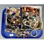 A tray containing a good collection of costume jewellery including bangles, necklaces,