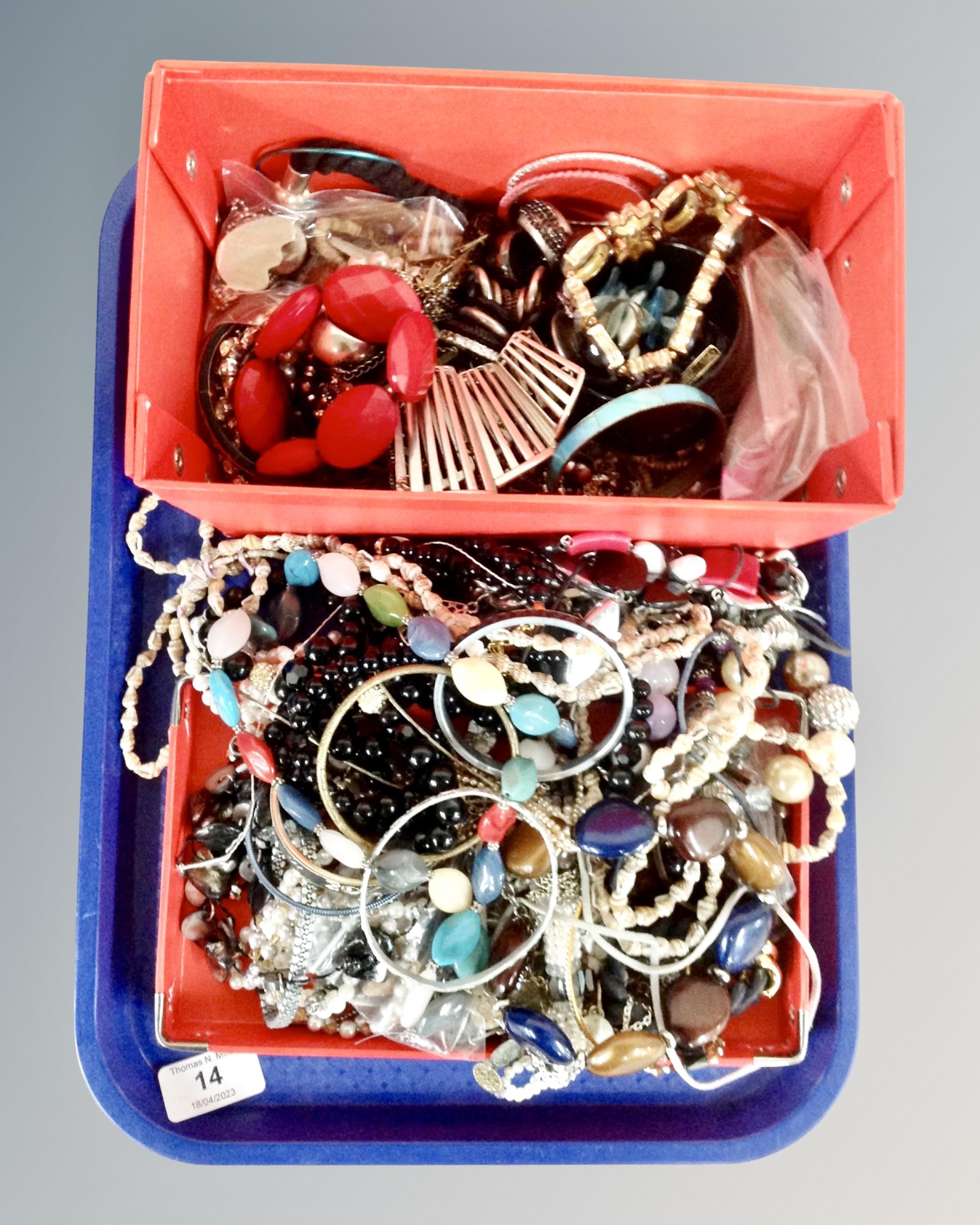 A tray containing a good collection of costume jewellery including bangles, bracelets,