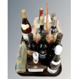 A tray containing a John Lewis four bottle wine gift set in wicker basket together with seven