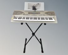 A Casio CTK-900 electric keyboard on stand with lead